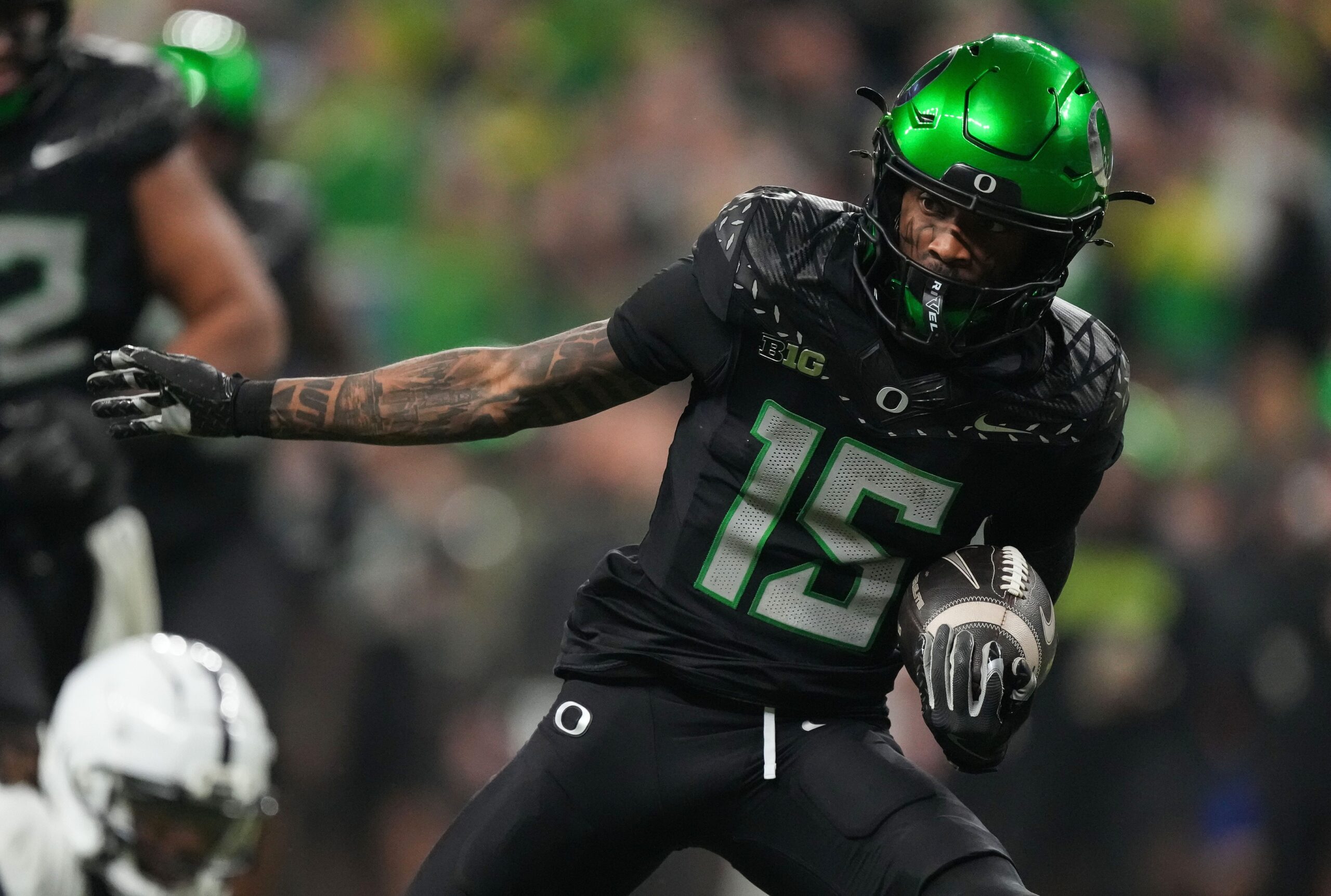 Oregon Ducks wide receiver Tez Johnson (15) rushes up the field Saturday, Dec. 7, 2024, during the Big Ten Championship game at Lucas Oil Stadium in Indianapolis.