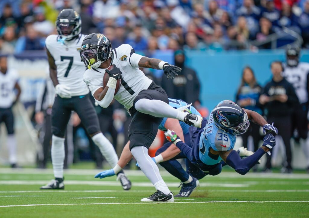 Jacksonville Jaguars running back Travis Etienne Jr. (1) eludes Tennessee Titans cornerback Daryl Worley (35) during the first quarter at Nissan Stadium