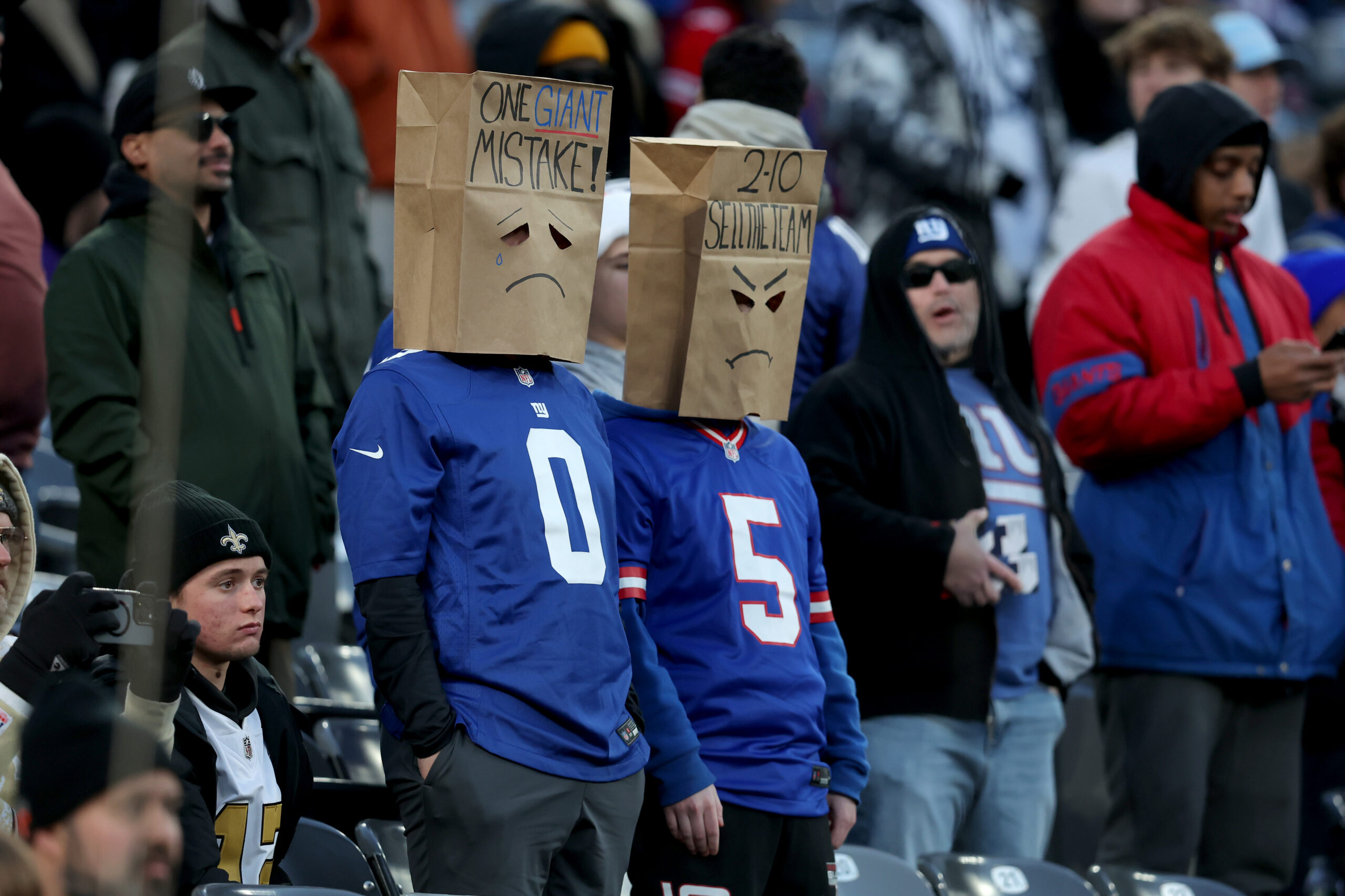 New York Giants fans wear paper bags on their heads during the fourth quarter against the New Orleans Saints at MetLife Stadium.