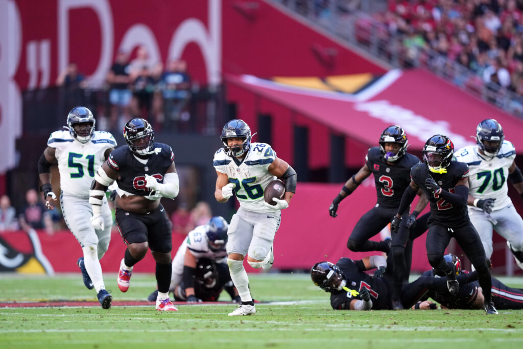 Seattle Seahawks running back Zach Charbonnet (26) runs for a touchdown against the Arizona Cardinals during the first half at State Farm Stadium.