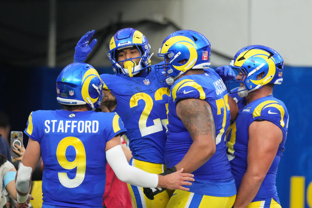 Los Angeles Rams running back Kyren Williams (23) celebrates with quarterback Matthew Stafford (9) and offensive tackle Alaric Jackson (77) after scoring in a 7-yard touchdown run against the Buffalo Bills in the third quarter at SoFi Stadium.