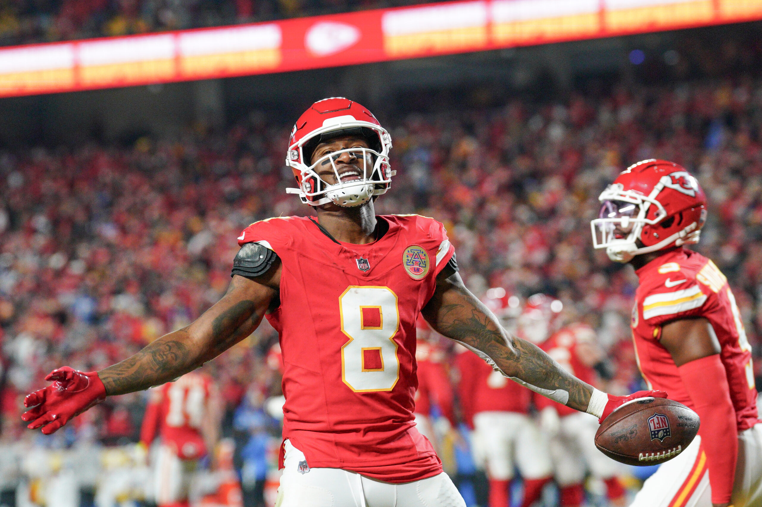 Kansas City Chiefs wide receiver DeAndre Hopkins (8) celebrates after scoring against the Los Angeles Chargers during the first half at GEHA Field at Arrowhead Stadium.