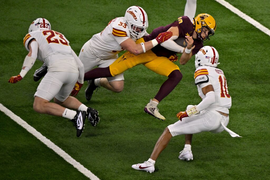 Dec 7, 2024; Arlington, TX, USA; Iowa State Cyclones linebacker Will McLaughlin (23) and linebacker Jack Sadowsky V (33) and defensive back Darien Porter (10) and Arizona State Sun Devils quarterback Sam Leavitt (10) in action during the game between the Iowa State Cyclones and the Arizona State Sun Devils at AT&T Stadium. Mandatory Credit: Jerome Miron-Imagn Images