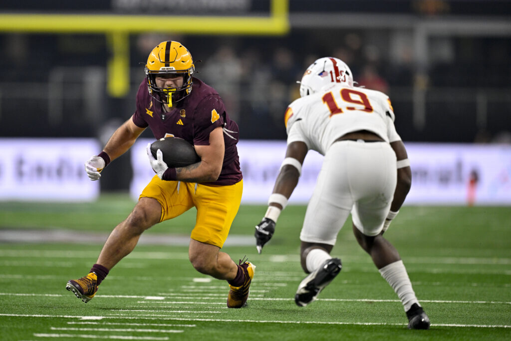 Arizona State Sun Devils running back Cam Skattebo (4) and Iowa State Cyclones defensive back Ta'Shawn James (19) in action during the game between the Iowa State Cyclones and the Arizona State Sun Devils at AT&T Stadium.