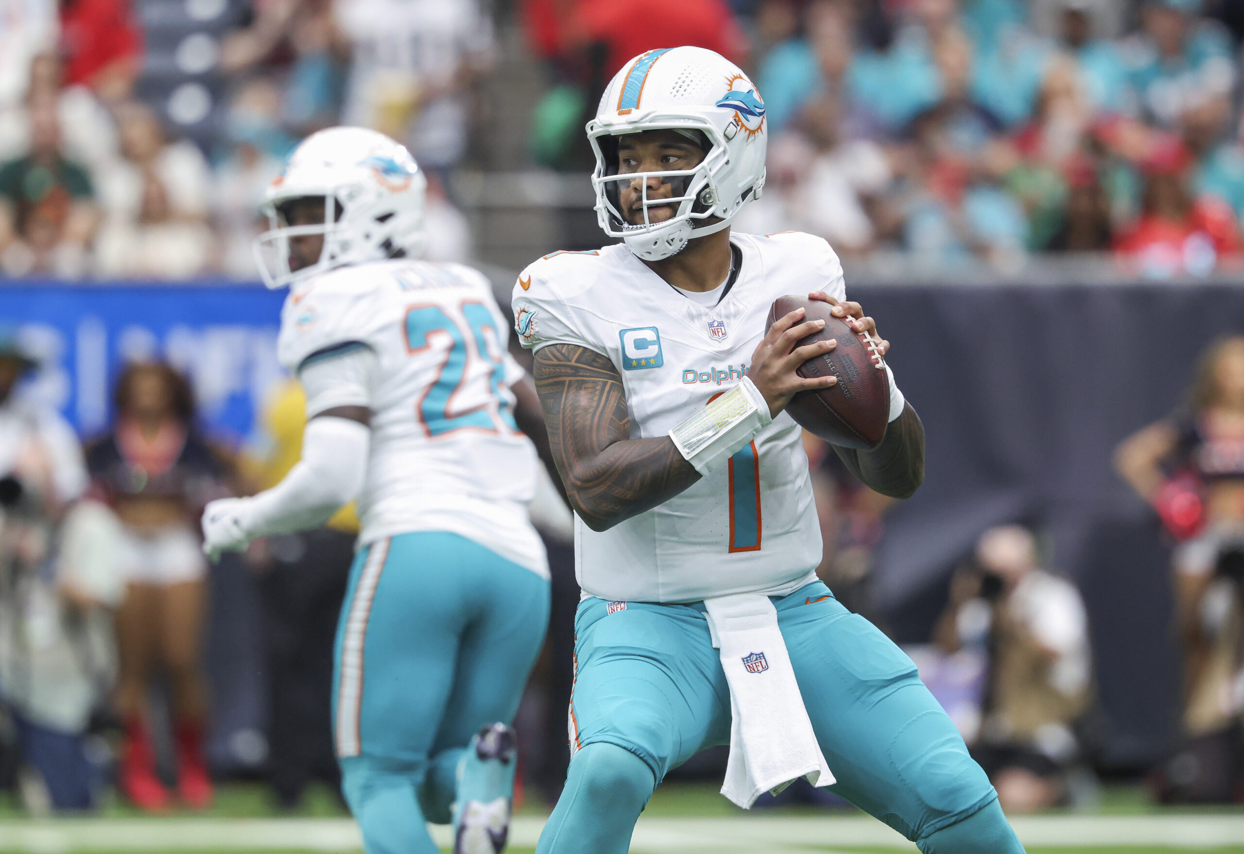 Miami Dolphins quarterback Tua Tagovailoa (1) looks for an open receiver during the first quarter against the Houston Texans at NRG Stadium.