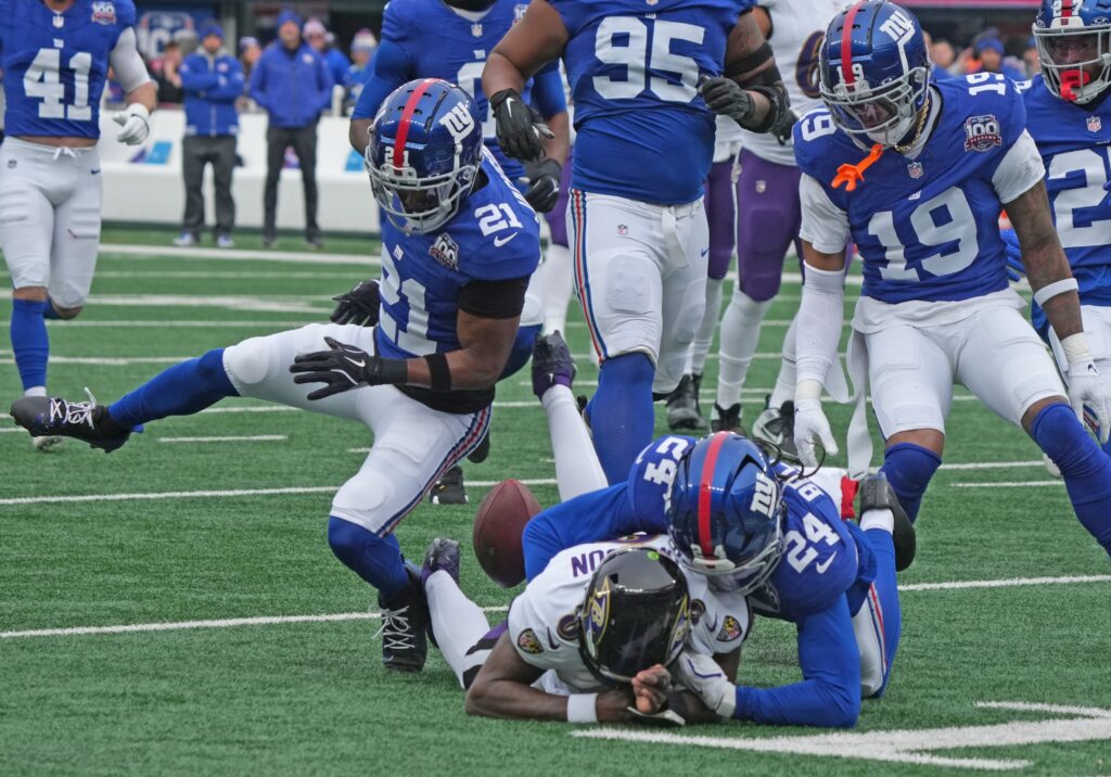 East Rutherford, NJ -- December 15, 2024 -- The Giants defense strips the ball from Lamar Jackson of the Ravens on the Ravens first drive of the game, causing a fumble recovered by the Giants.