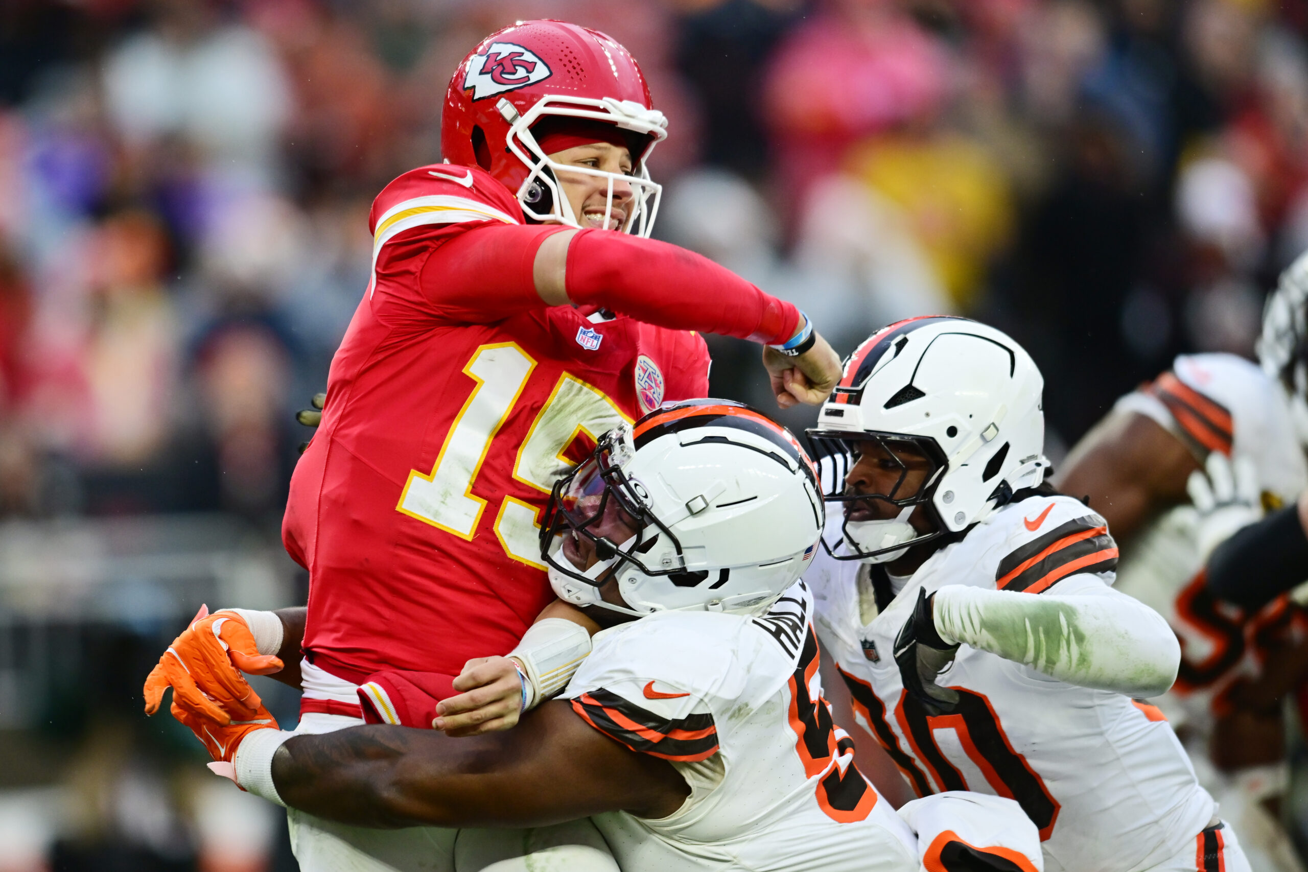 Cleveland Browns defensive tackle Mike Hall Jr. (51) and linebacker Devin Bush (30) rush Kansas City Chiefs quarterback Patrick Mahomes (15) during the second half at Huntington Bank Field.