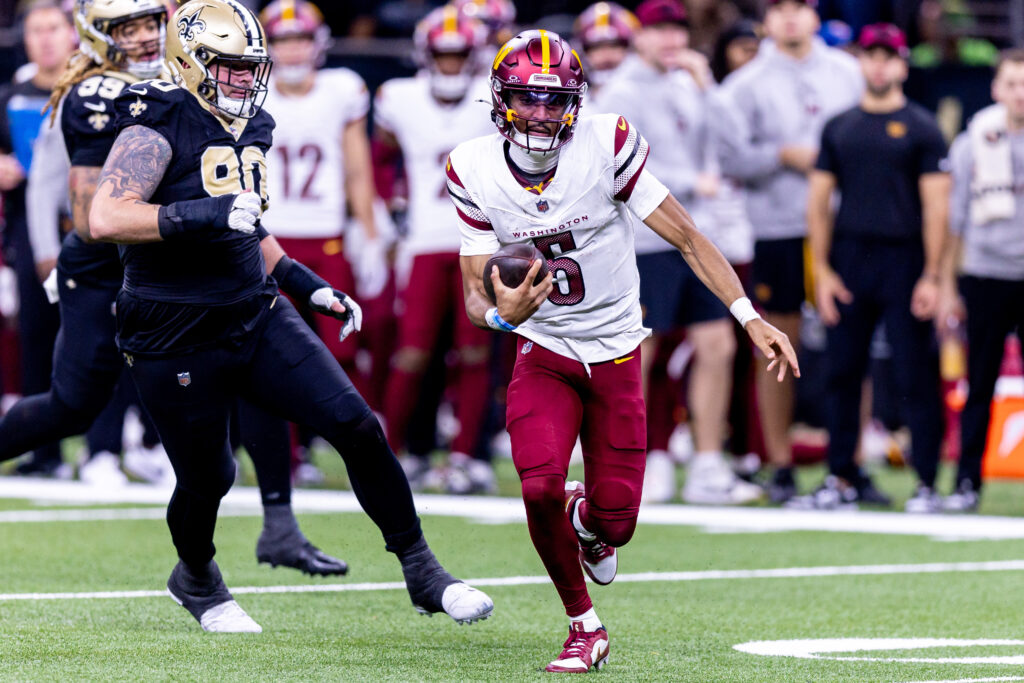 Washington Commanders quarterback Jayden Daniels (5) scrambles against the New Orleans Saints during the second half at Caesars Superdome. 