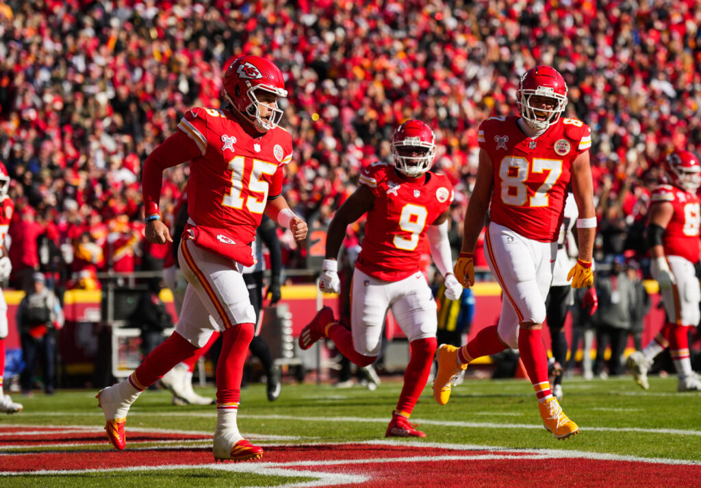 Kansas City Chiefs quarterback Patrick Mahomes (15) celebrates with tight end Travis Kelce (87) and wide receiver JuJu Smith-Schuster (9) after scoring a touchdown during the first half against the Houston Texans at GEHA Field. 