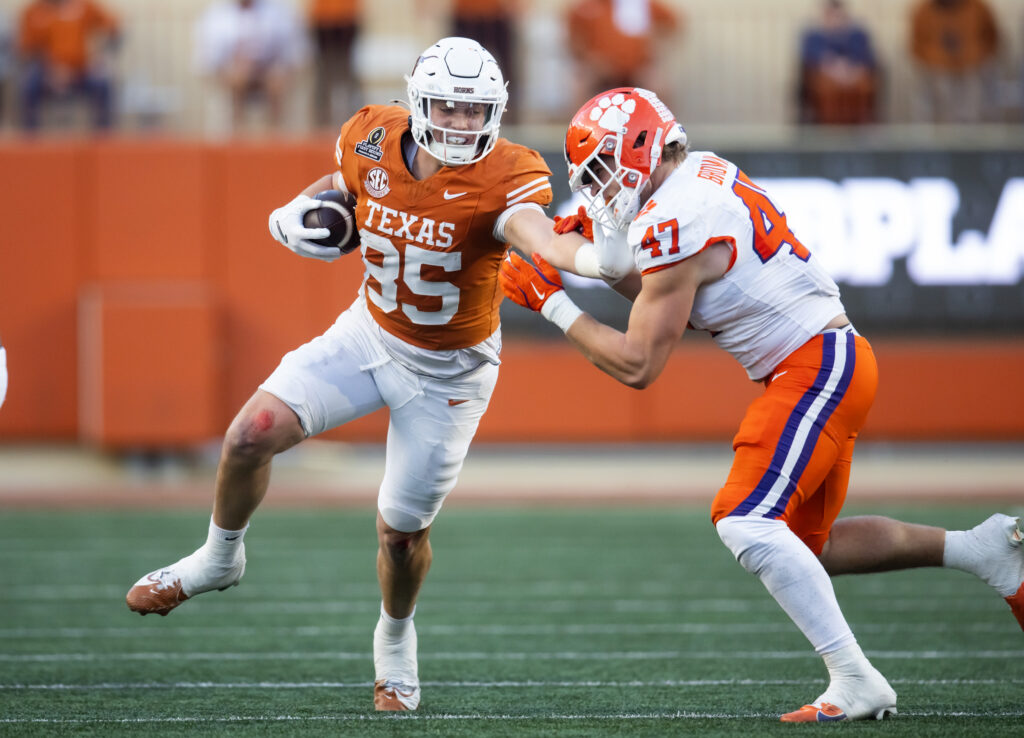 Texas Longhorns tight end Gunnar Helm (85) stiff arms Clemson Tigers linebacker Sammy Brown (47) during the second half of the CFP National playoff first round.