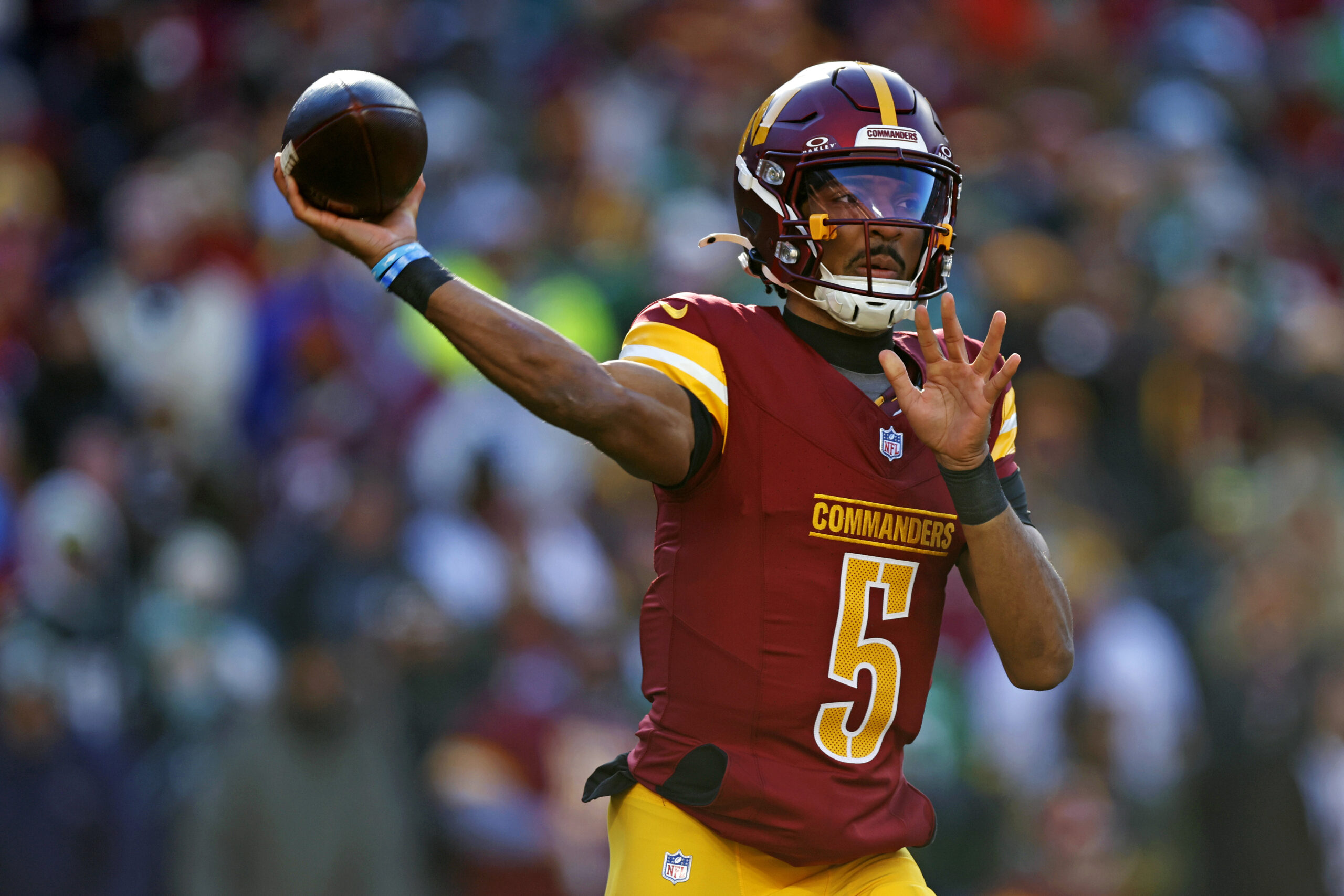 Washington Commanders quarterback Jayden Daniels (5) throws a pass during the first quarter against the Philadelphia Eagles at Northwest Stadium.