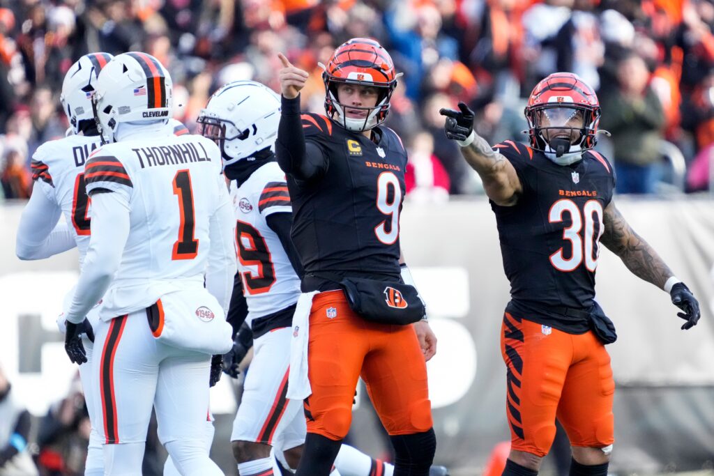 Cincinnati Bengals quarterback Joe Burrow (9) and running back Chase Brown (30) celebrate after a first down run by Burrow in the second quarter of the NFL Week 16 game between the Cincinnati Bengals and the Cleveland Browns at Paycor Stadium in downtown Cincinnati.