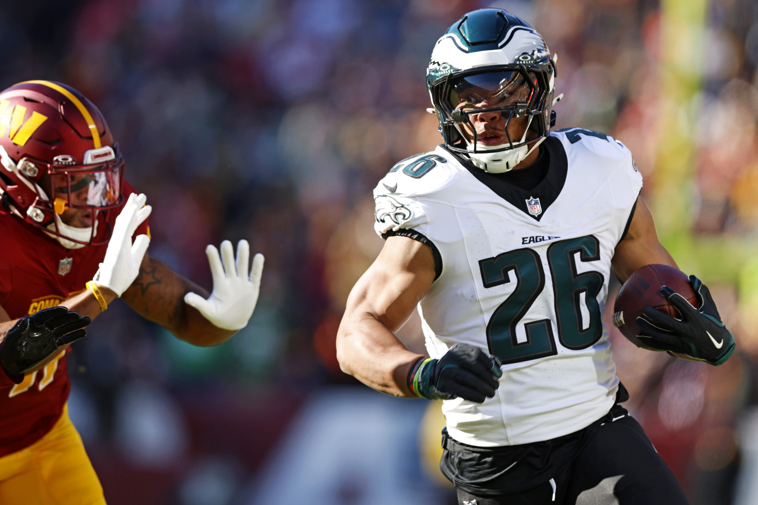 Philadelphia Eagles running back Saquon Barkley (26) runs the ball during the first quarter against the Washington Commanders at Northwest Stadium.