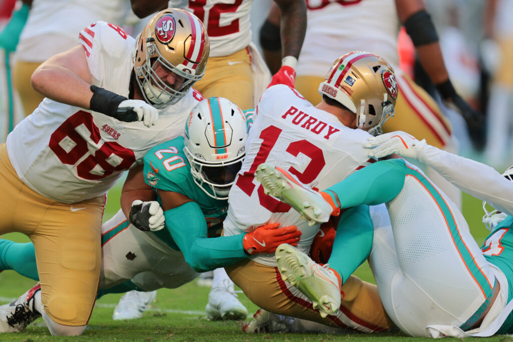 Miami Dolphins linebacker Jordyn Brooks (20) sacks San Francisco 49ers quarterback Brock Purdy (13) during the first quarter at Hard Rock Stadium.