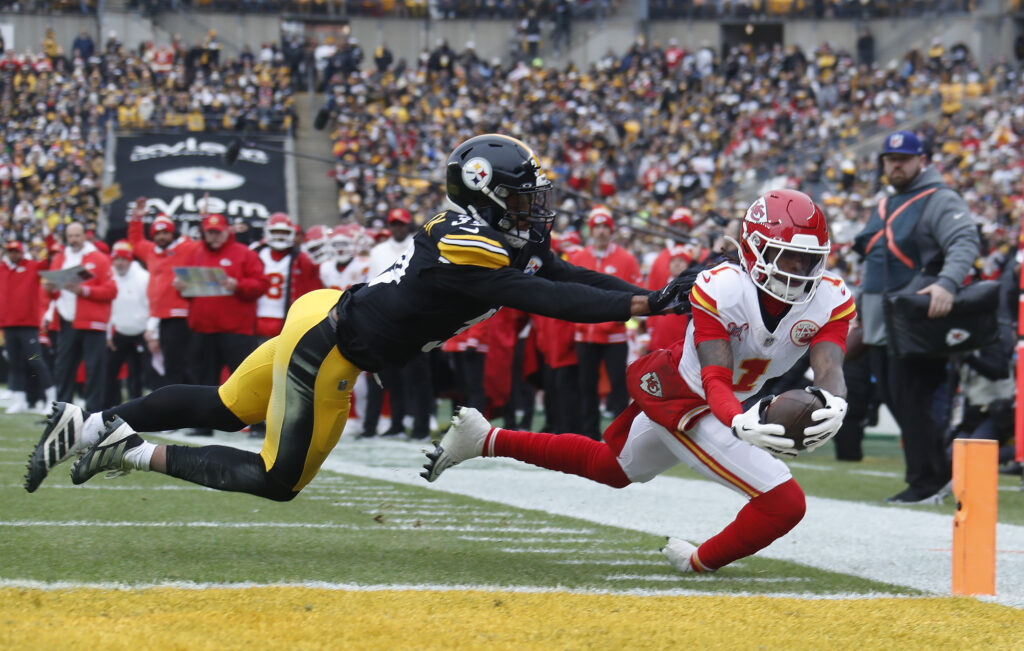 Kansas City Chiefs wide receiver Xavier Worthy (1) dives past Pittsburgh Steelers safety Minkah Fitzpatrick (39) into the end-zone for a touchdown during the first quarter at Acrisure Stadium.