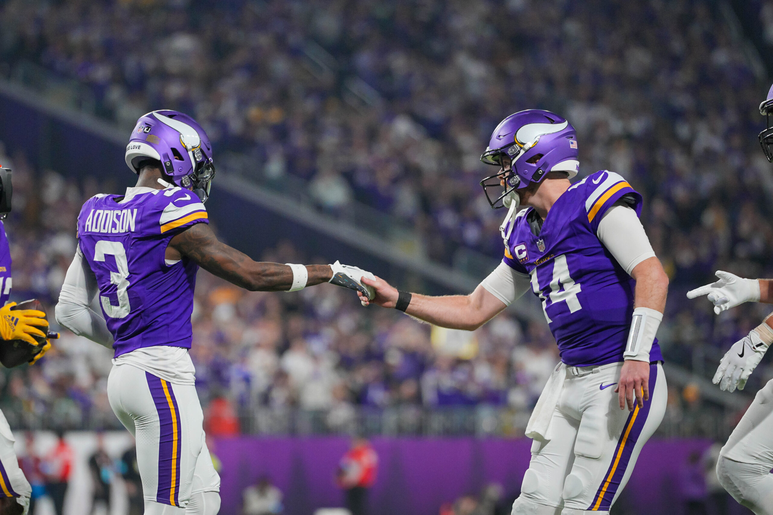 Minnesota Vikings wide receiver Jordan Addison (3) celebrates his touchdown with quarterback Sam Darnold (14) against Green Bay Packers at U.S. Bank Stadium.