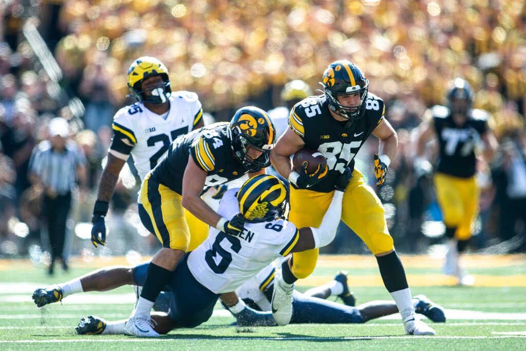 Iowa tight end Luke Lachey (85) gets tackled by Michigan defensive back R.J. Moten during a NCAA Big Ten Conference college football game.