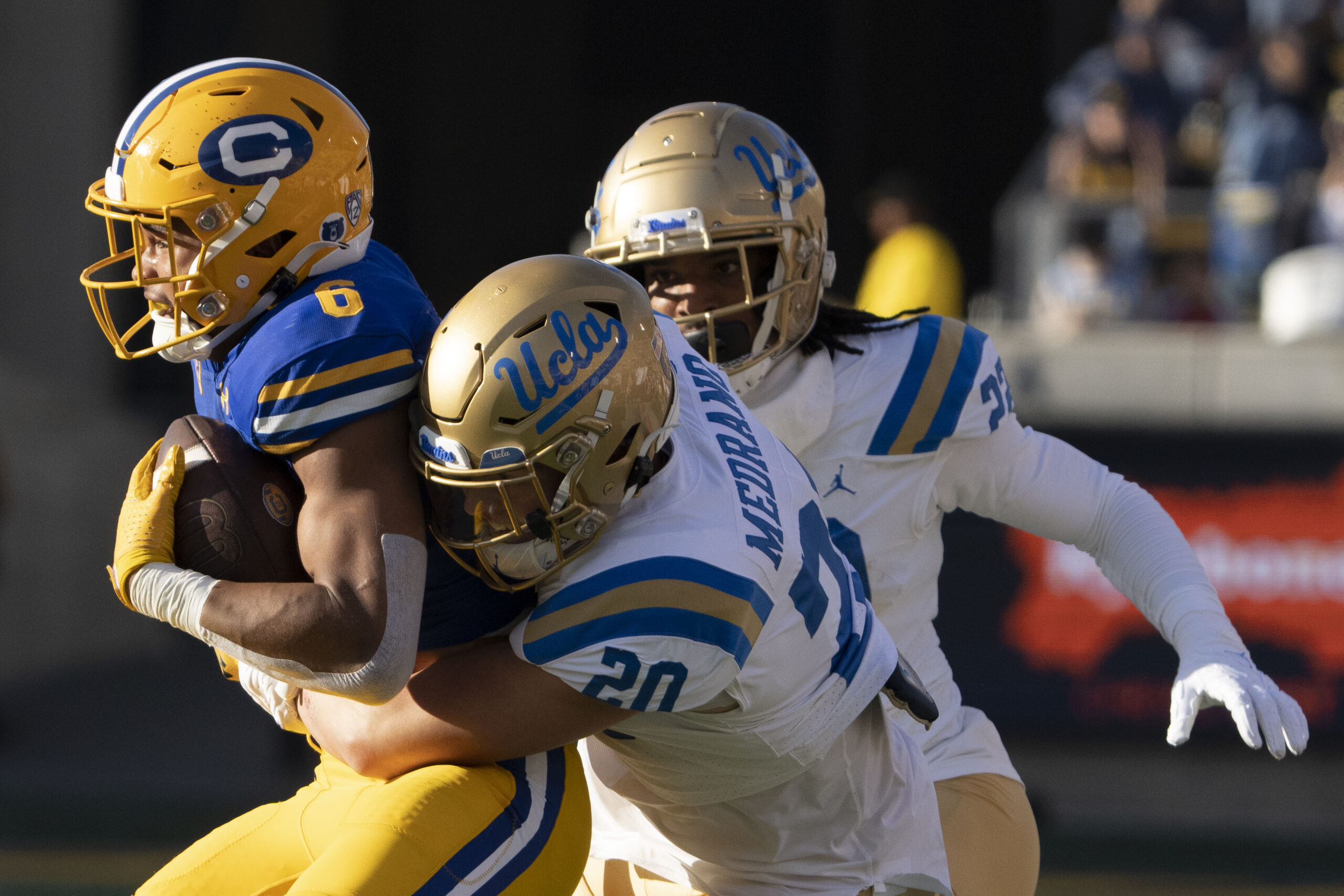 California Golden Bears running back Jaydn Ott (6) is tackled by UCLA Bruins linebacker Kain Medrano (20) during the second quarter at California Memorial Stadium.