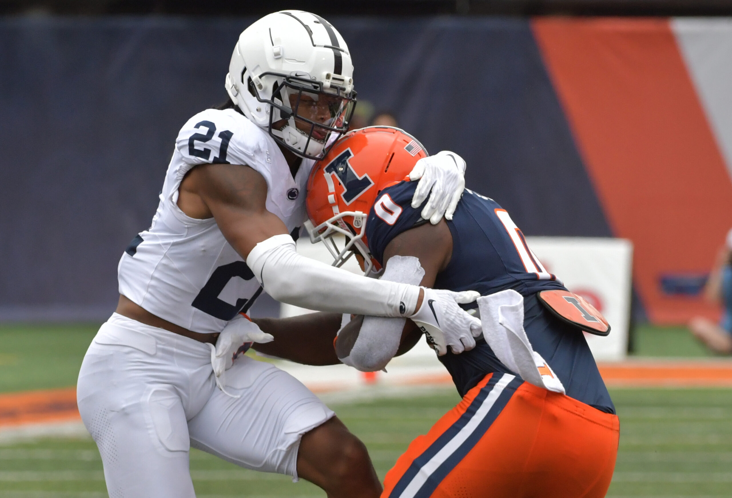 Penn State Nittany Lions safety Kevin Winston Jr. (21) tackles Illinois Fighting Illini running back Josh McCray (0) after McCray caught a short pass during the second half at Memorial Stadium.