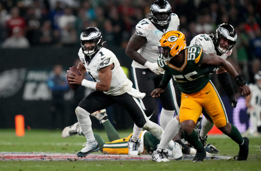 Philadelphia Eagles quarterback Jalen Hurts (1) scrambles against Green Bay Packers defensive end Kingsley Enagbare (55) during the first half at Neo Quimica Arena.