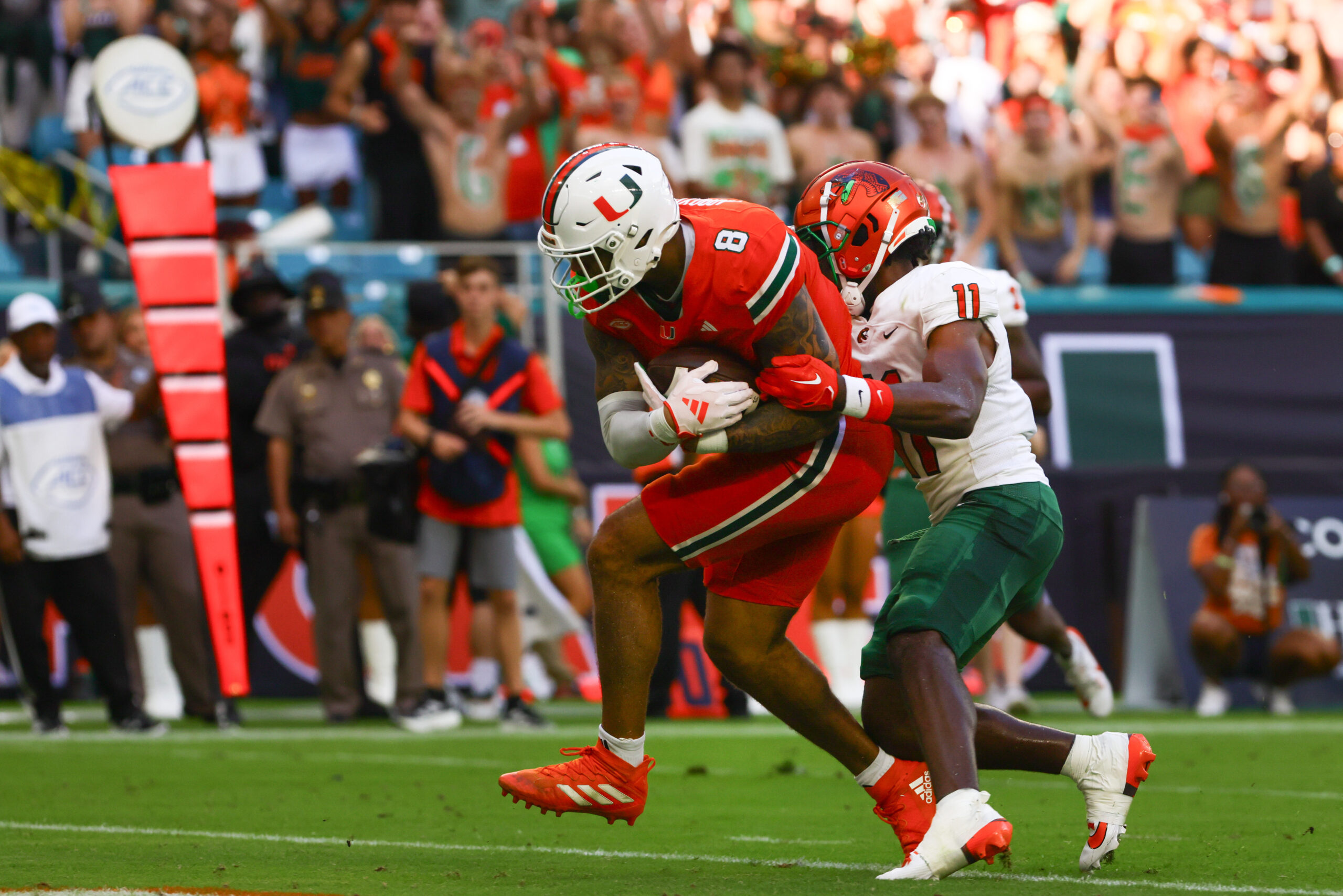 Miami Hurricanes tight end Elijah Arroyo (8) scores a touchdown against Florida A&M Rattlers defensive back Deco Wilson (11).