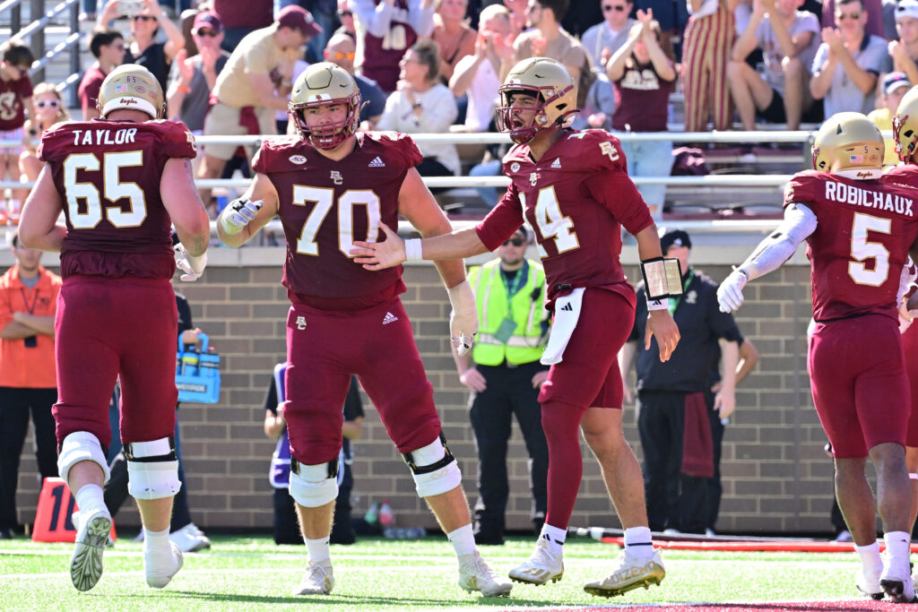 Boston College Eagles quarterback Grayson James (14) celebrates his touchdown with teammates offensive lineman Logan Taylor (65) and offensive lineman Ozzy Trapilo (70) during the second half against the Western Kentucky Hilltoppers.