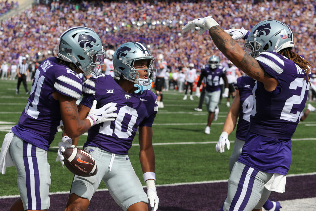 Kansas State Wildcats cornerback Jacob Parrish (10) celebrates with safety Marques Sigle (21) and linebacker Asa Newsom (23) after intercepting a pass against the Oklahoma State Cowboys in the third quarter. 