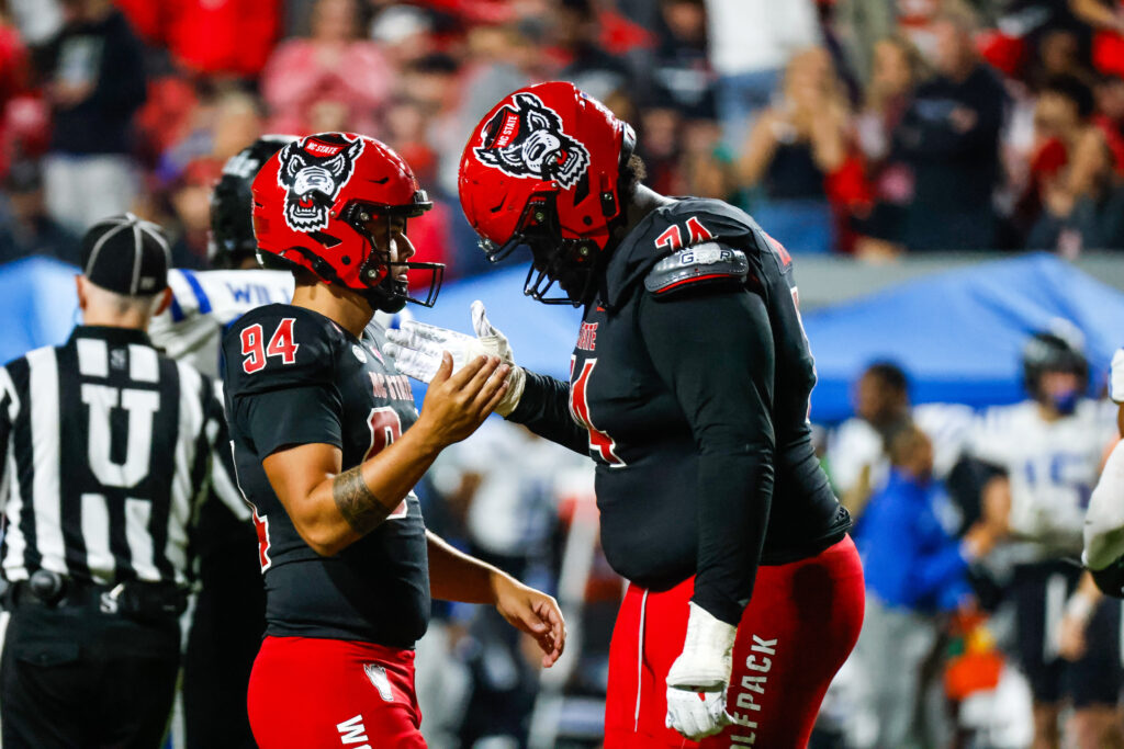 North Carolina State Wolfpack place kicker Kanoah Vinesett (94) and  offensive tackle Anthony Belton (74) celebrate during the second half of the game against Duke Blue Devils.