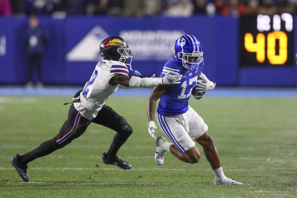 Brigham Young Cougars wide receiver Keelan Marion (17) is tackled after a catch by Kansas Jayhawks cornerback Cobee Bryant (2).