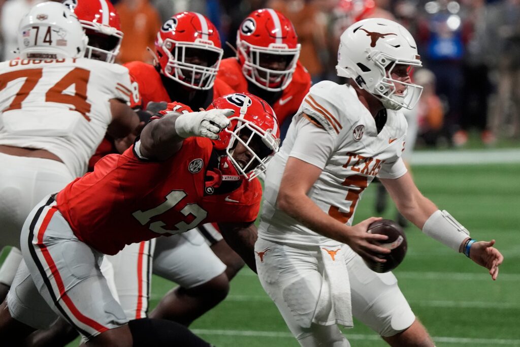 Georgia defensive lineman Mykel Williams (13) goes in for a sack on Texas quarterback Quinn Ewers (3) during the second half of the SEC championship game.