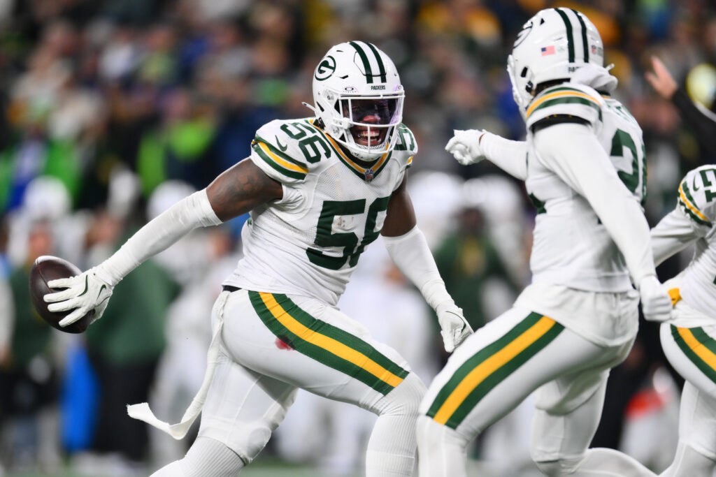 Green Bay Packers linebacker Edgerrin Cooper (56) celebrates with cornerback Carrington Valentine (24) after Cooper intercepted the ball. 