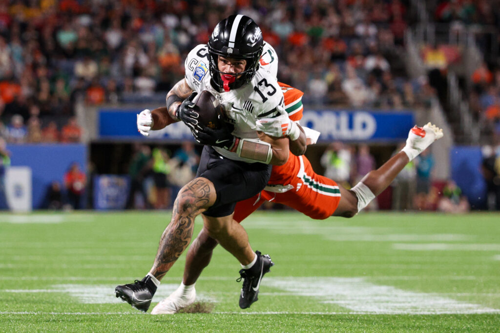 Iowa State Cyclones wide receiver Jaylin Noel (13) receives a pass defended by Miami Hurricanes defensive back D'Yoni Hill (19) in the fourth quarter.