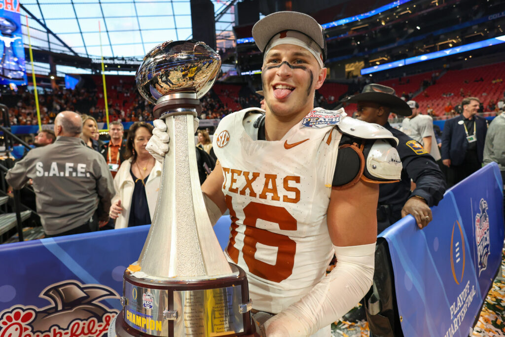 Texas Longhorns defensive back Michael Taaffe (16) poses with the trophy after a victory over the Arizona State Sun Devils in the Peach Bowl at Mercedes-Benz Stadium.