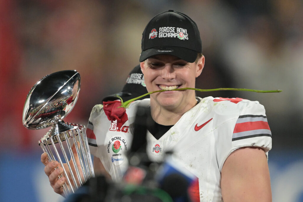 Ohio State Buckeyes quarterback Will Howard (18) celebrates with the Leishman Trophy after defeating the Oregon Ducks in the 2025 Rose Bowl college football quarterfinal game at Rose Bowl Stadium.