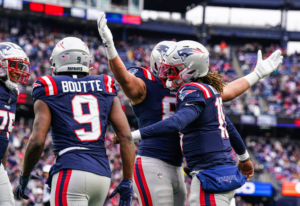 New England Patriots tight end Austin Hooper (81) congratulates quarterback Joe Milton III (19) after his touchdown run against the Buffalo Bills in the first quarter at Gillette Stadium. 