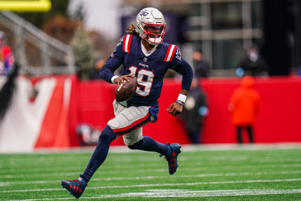 New England Patriots quarterback Joe Milton III (19) runs the ball against the Buffalo Bills in the first half at Gillette Stadium.