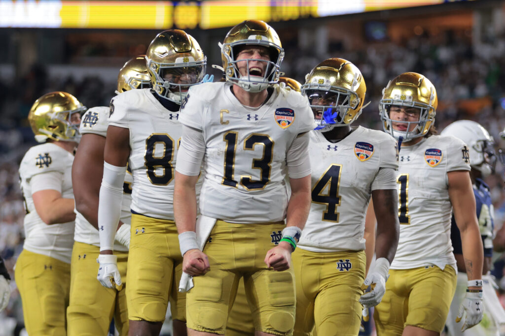 Notre Dame Fighting Irish quarterback Riley Leonard (13) celebrates a touch down with teammates in the second half against the Penn State Nittany Lions in the Orange Bowl at Hard Rock Stadium.