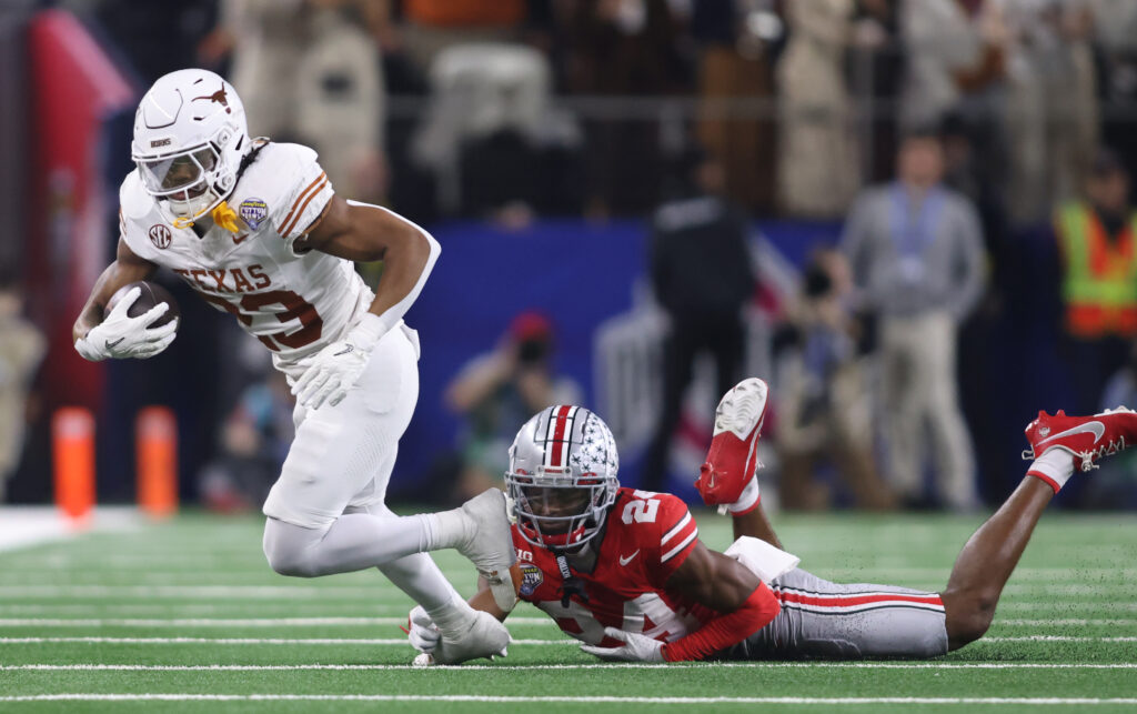 Texas Longhorns running back Jaydon Blue (23) is tackled by Ohio State Buckeyes cornerback Jermaine Mathews Jr. (24) during the third quarter of the College Football Playoff semifinal in the Cotton Bowl at AT&T Stadium.