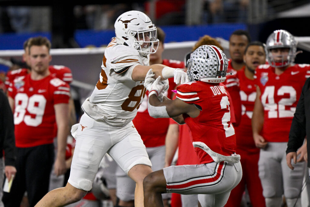 Texas Longhorns tight end Gunnar Helm (85) shoves Ohio State Buckeyes safety Caleb Downs (2) and draws a penalty during the game between the Texas Longhorns and the Ohio State Buckeyes. 