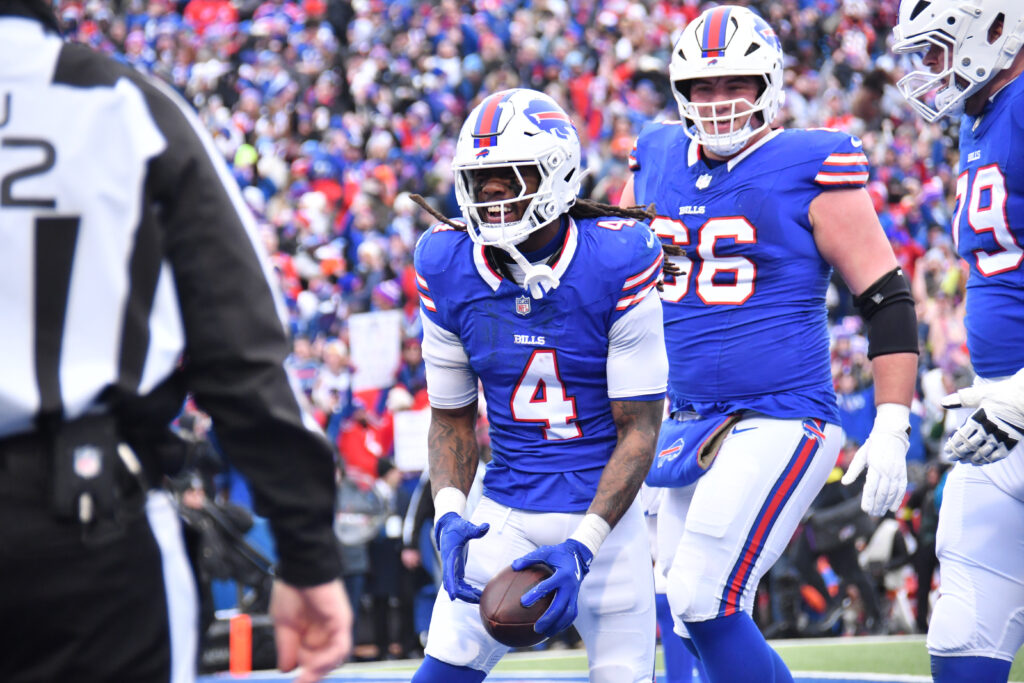 Buffalo Bills running back James Cook (4) celebrates a touchdown during the second quarter against the Denver Broncos in an AFC wild card game at Highmark Stadium. 