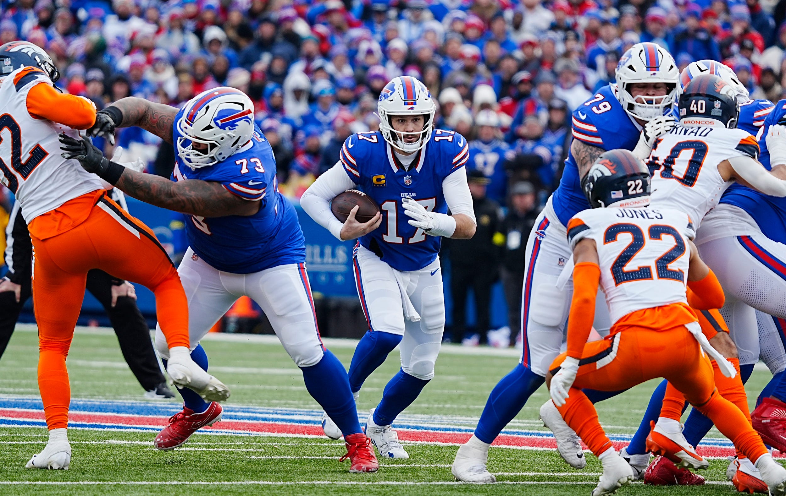 Buffalo Bills quarterback Josh Allen (17) runs for a gain of about three yards during the first half of the Buffalo Bills wild card game against the Denver Broncos at Highmark Stadium.