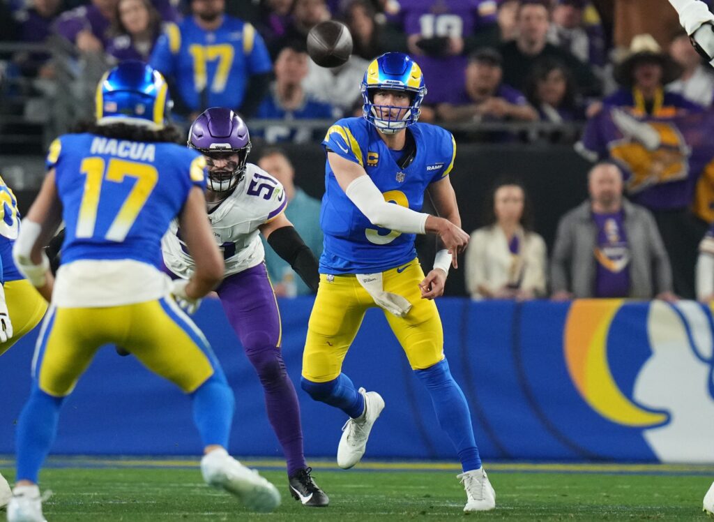 Los Angeles Rams quarterback Matthew Stafford (9) throws the ball to receiver Puka Nacua (17) against the Minnesota Vikings during their playoff game at State Farm Stadium.