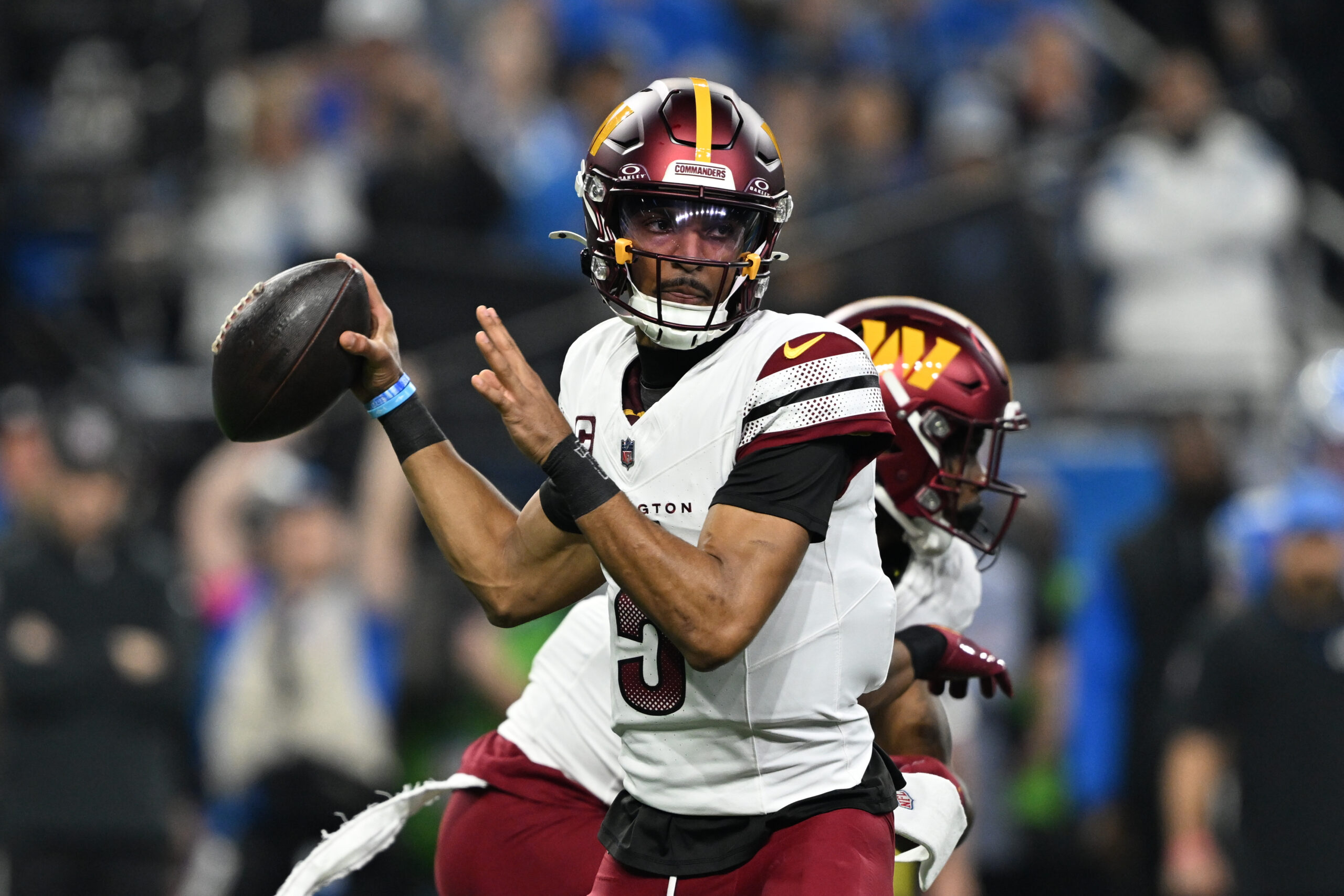 Washington Commanders quarterback Jayden Daniels (5) throws a pass during the first quarter against Detroit Lions in a 2025 NFC divisional round game at Ford Field. Lon Horwedel-Imagn Images