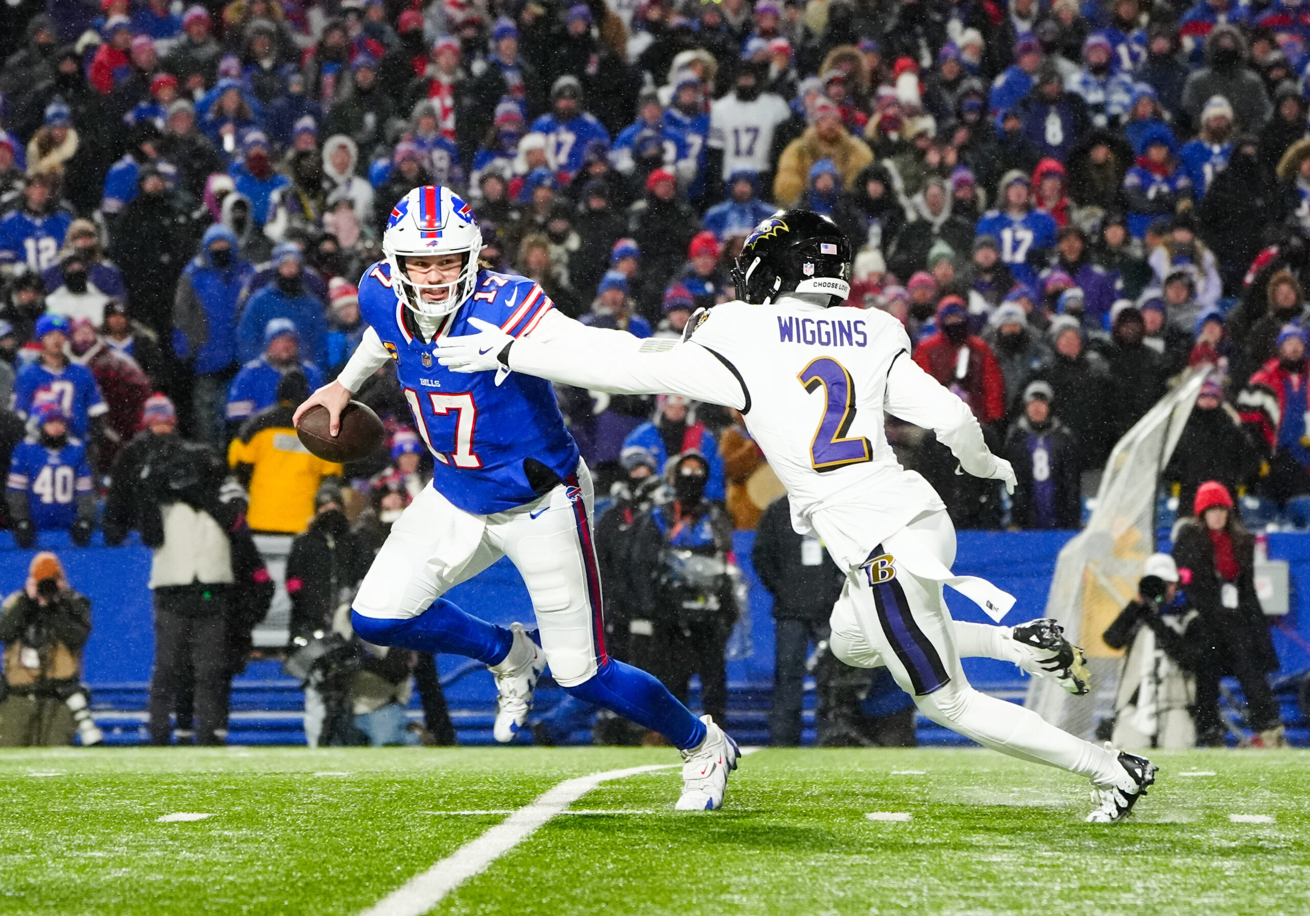 Baltimore Ravens cornerback Nate Wiggins (2) looks to sack Buffalo Bills quarterback Josh Allen (17) during the third quarter in a 2025 AFC divisional round game at Highmark Stadium.