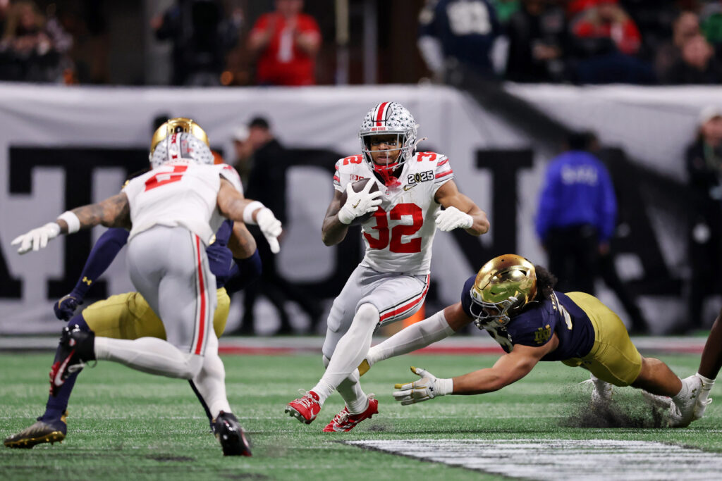 Ohio State Buckeyes running back TreVeyon Henderson (32) runs with the ball against the Notre Dame Fighting Irish during the first half the CFP National Championship college football game. 