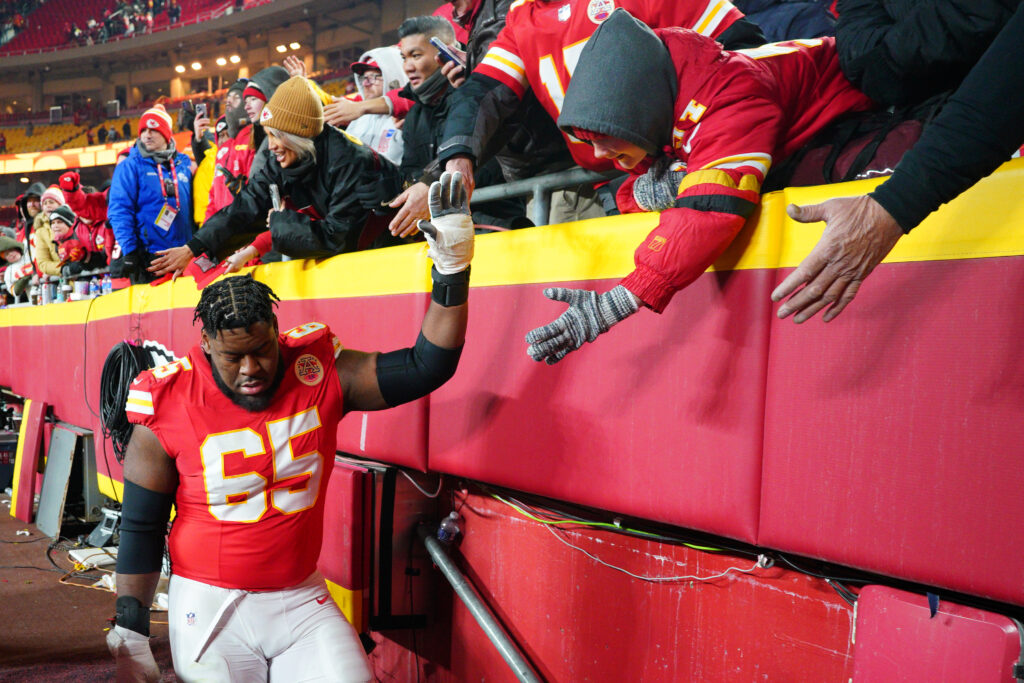 Kansas City Chiefs guard Trey Smith (65) greets fans while leaving the field after a 2025 AFC divisional round game against the Houston Texans. 