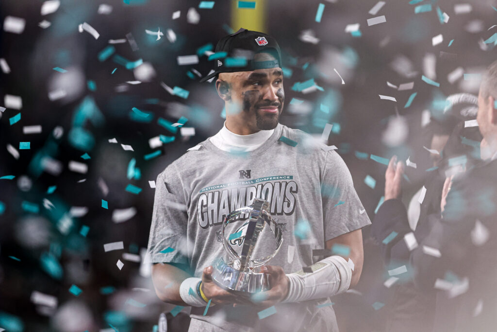 Philadelphia Eagles quarterback Jalen Hurts (1) holds the NFC Championship trophy after a victory in the NFC Championship game against the Washington Commanders at Lincoln Financial Field.