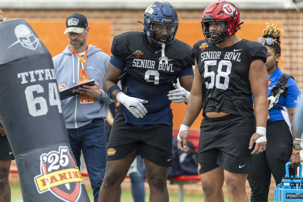 National team defensive lineman Darius Alexander of Toledo (9) and National team defensive lineman Junior Tafuna of Utah (58) talks as they go through drills during Senior Bowl practice.