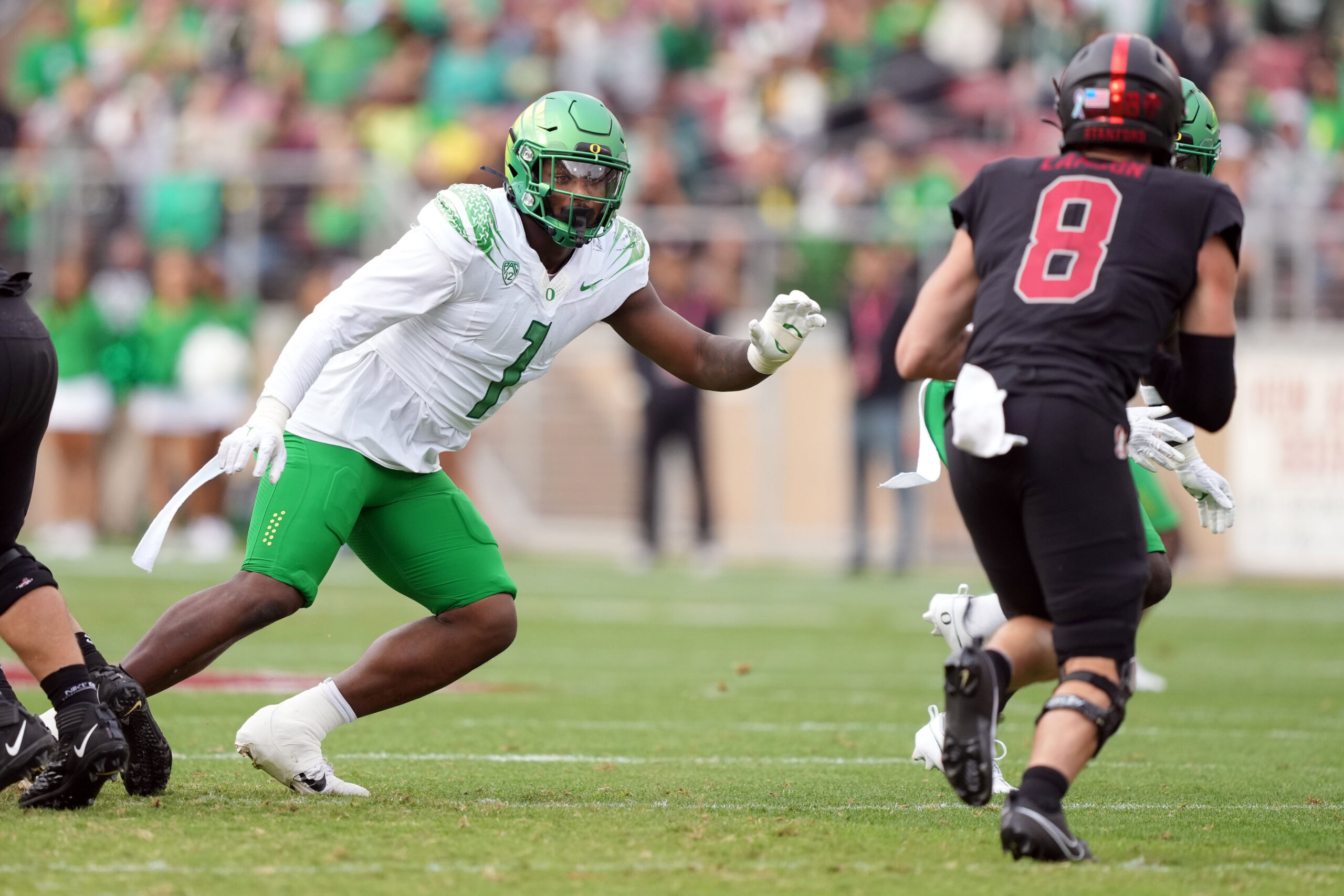 Oregon Ducks defensive end Jordan Burch (1) pursues Stanford Cardinal quarterback Justin Lamson (8) during the second quarter at Stanford Stadium.