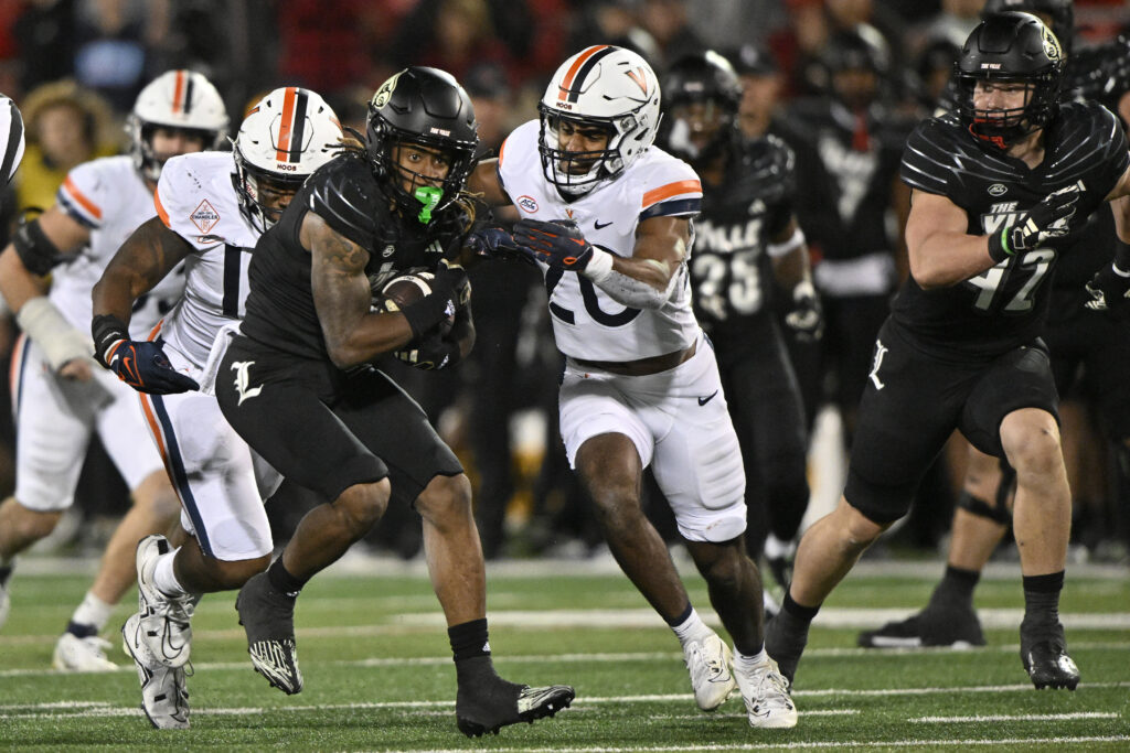 Louisville Cardinals wide receiver Kevin Coleman (3) runs the ball against Virginia Cavaliers safety Jonas Sanker (20) during the second half at L&N Federal Credit Union Stadium